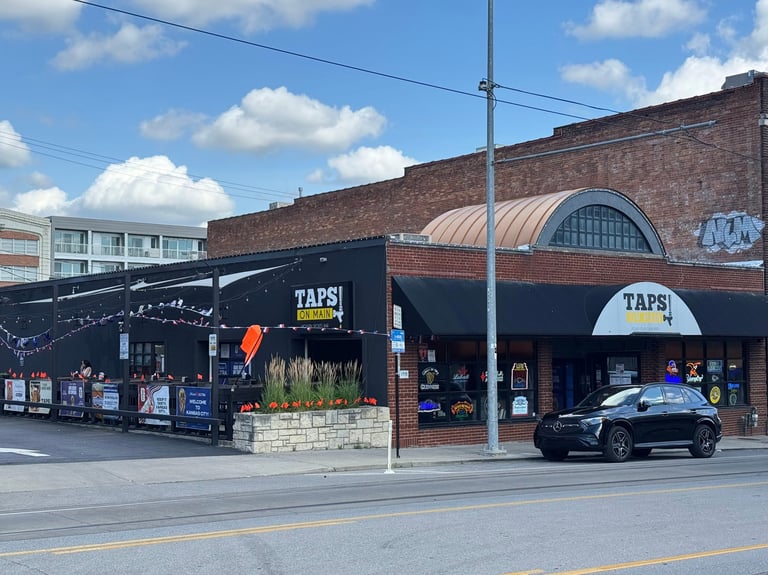 Taps On Main Kansas City commercial permanent LED lighting installed on brick storefront with awning