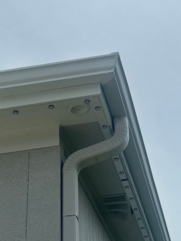 Kansas City permanent LED lighting installation detail at building corner with gutter and downspout