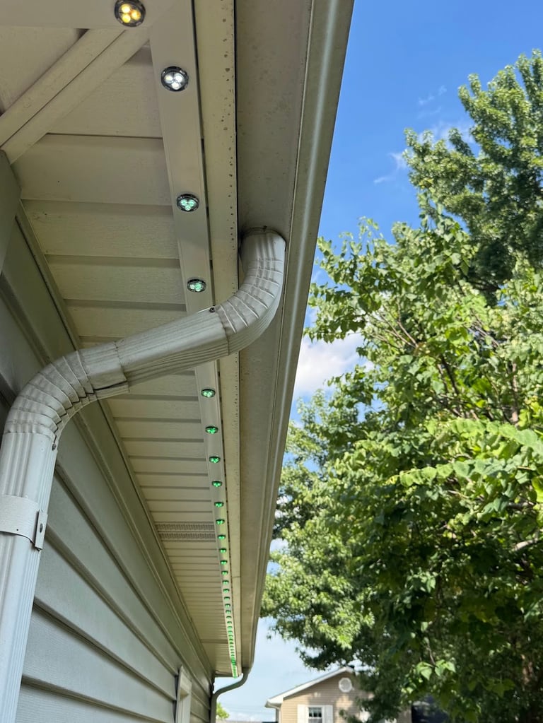Kansas City home with permanent LED lighting on beige vinyl soffit and gutter straight run