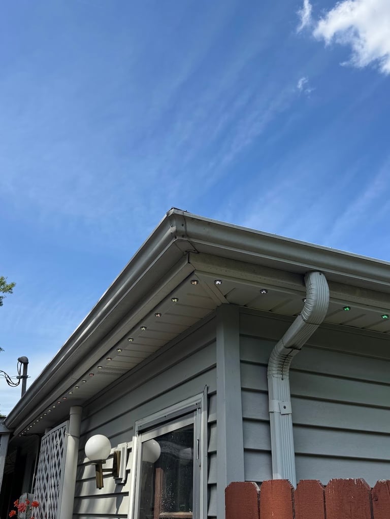 Kansas City home with permanent LED soffit lighting installed on gray siding, corner and straight run