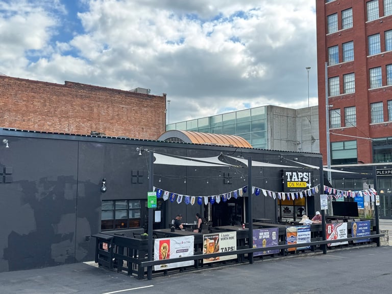 Kansas City commercial installation at Taps On Main with permanent LED lighting and patio bunting