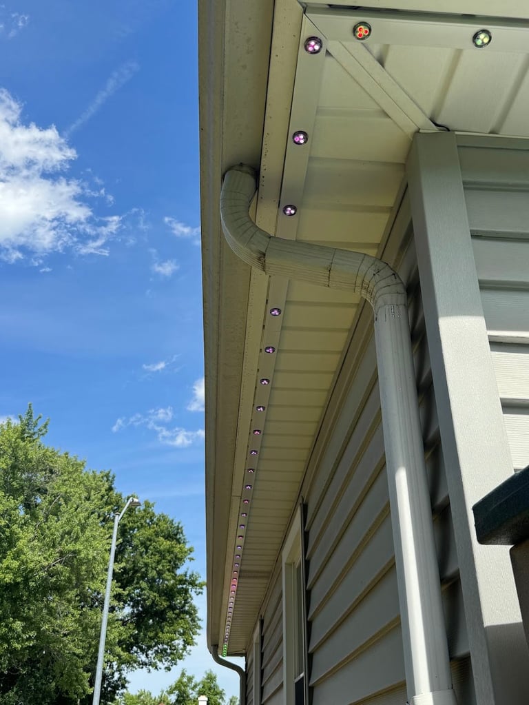 Recessed permanent LED lighting fixtures mounted along overhang of Kansas City building