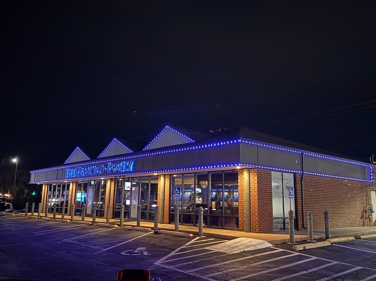 Brick commercial building with blue LED lights illuminated at night